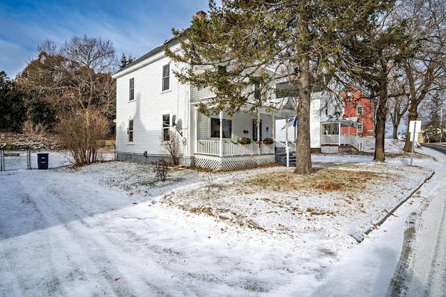 view of snow covered exterior with covered porch