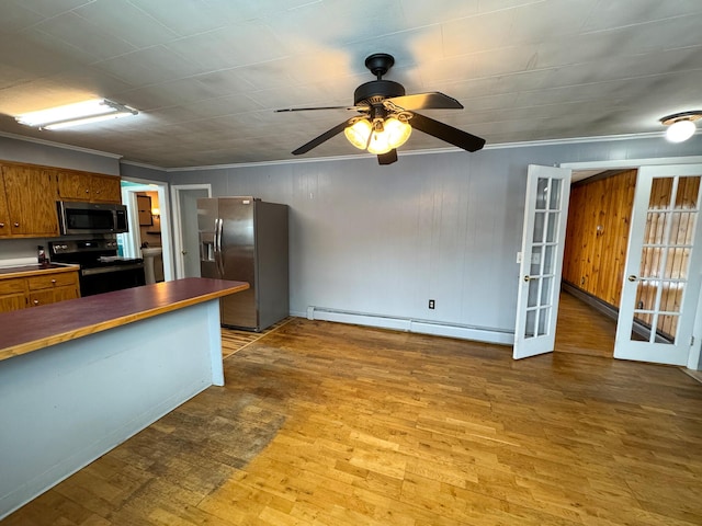 kitchen with french doors, ceiling fan, a baseboard radiator, crown molding, and appliances with stainless steel finishes