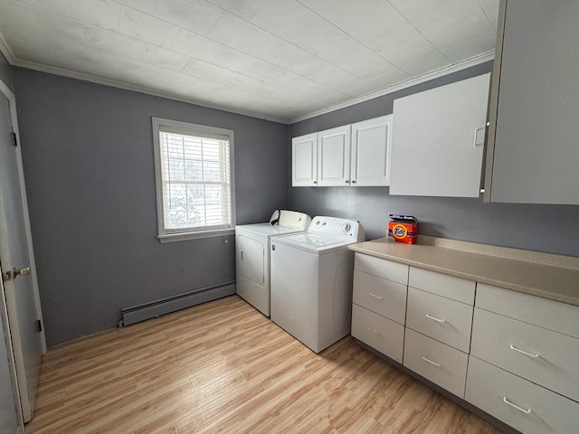 laundry area with light hardwood / wood-style floors, cabinets, crown molding, washing machine and clothes dryer, and a baseboard radiator