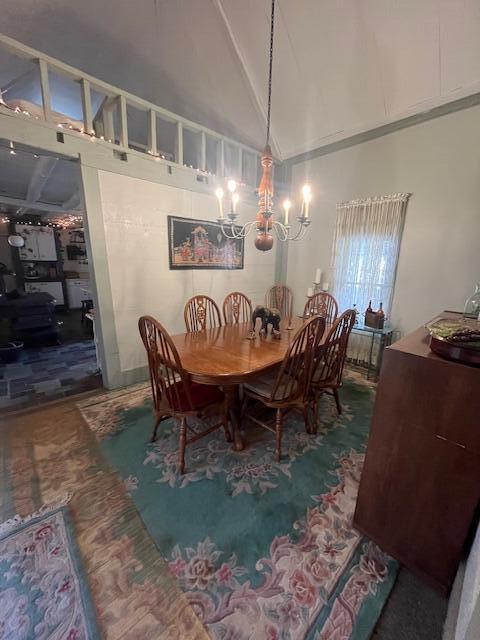 dining space with a chandelier and high vaulted ceiling