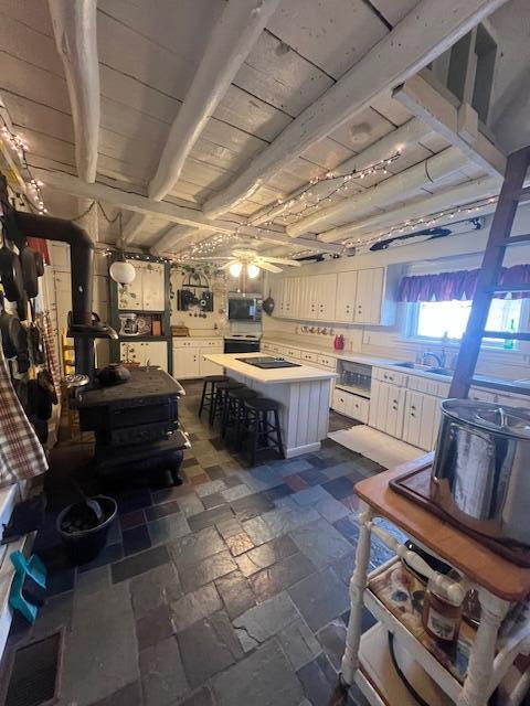 interior space with sink, wood ceiling, and a workshop area