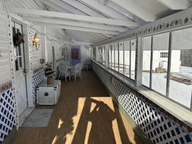 sunroom with a wealth of natural light and vaulted ceiling with beams