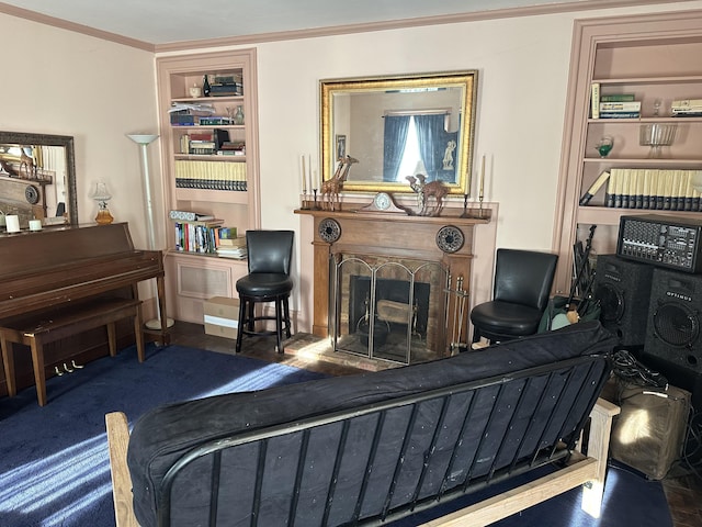 living area with built in shelves and ornamental molding