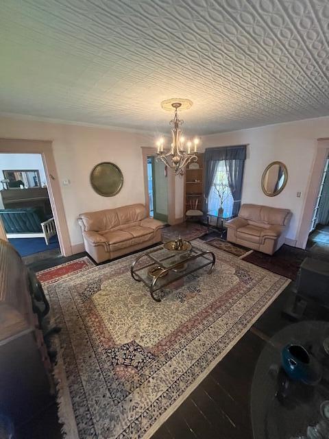 living room featuring an inviting chandelier and hardwood / wood-style floors