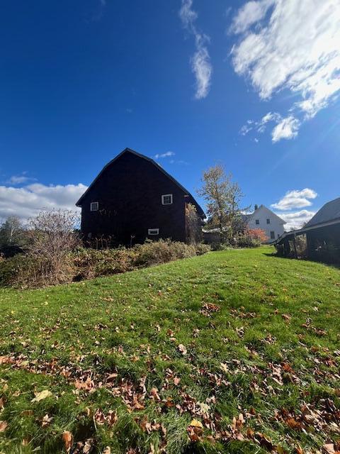 view of property exterior with a yard