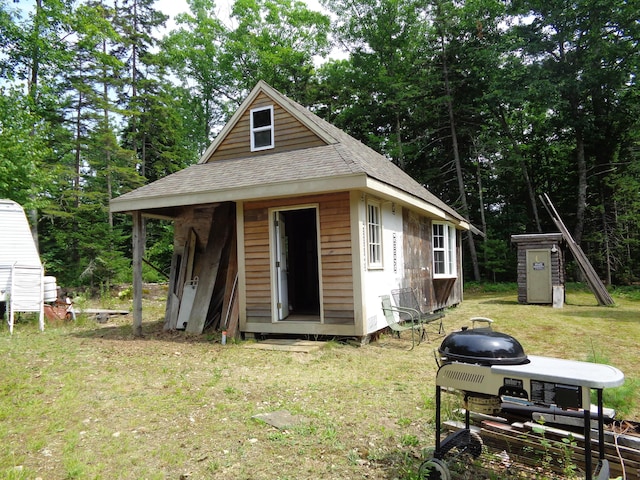 view of outbuilding with a lawn