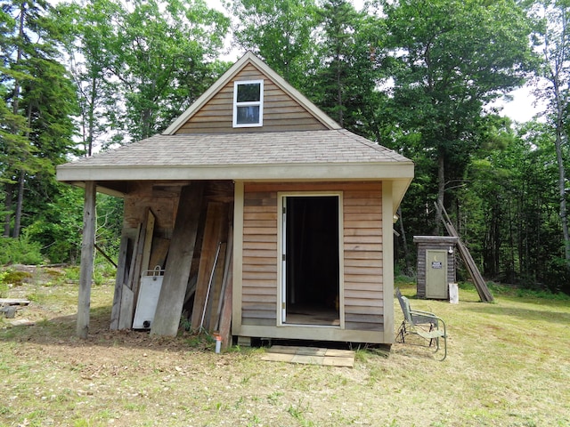 view of outbuilding with a yard