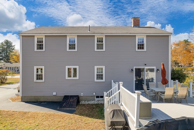 rear view of house featuring a deck