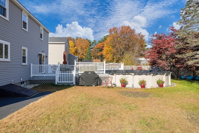 view of yard with a pool side deck