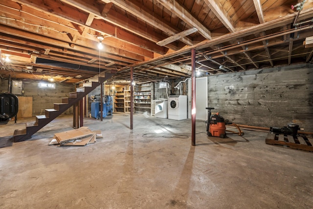 basement with washing machine and dryer and electric panel