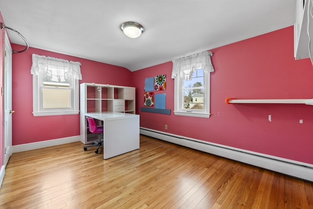 office area featuring baseboard heating and light hardwood / wood-style floors