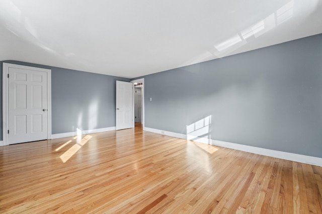 empty room with light hardwood / wood-style flooring