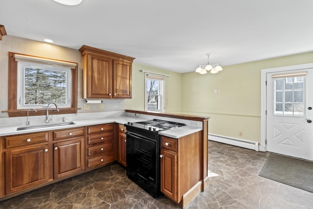 kitchen with sink, black electric range, a baseboard heating unit, kitchen peninsula, and pendant lighting