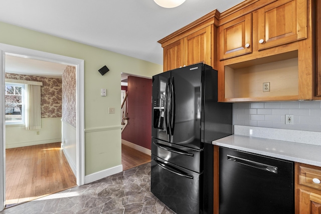 kitchen with black appliances and decorative backsplash