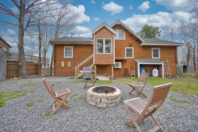 rear view of house with a fire pit