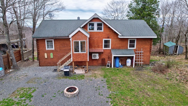 rear view of property with a fire pit