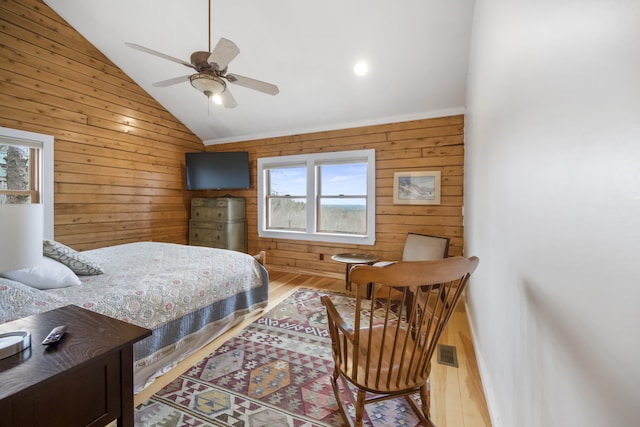 bedroom with ceiling fan, light hardwood / wood-style flooring, and vaulted ceiling