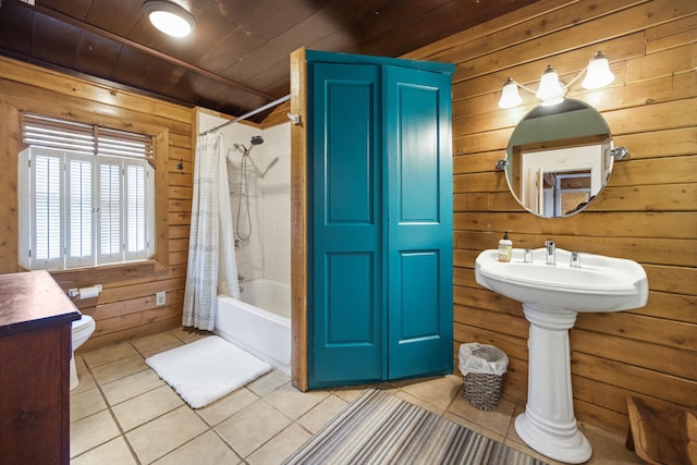 bathroom with tile patterned flooring, wooden ceiling, toilet, wooden walls, and shower / bath combo