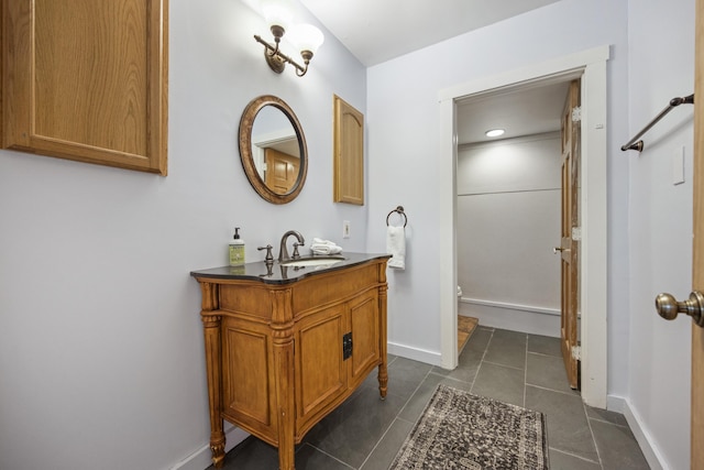 bathroom with toilet, tile patterned flooring, and vanity