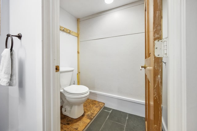 bathroom featuring tile patterned flooring and toilet