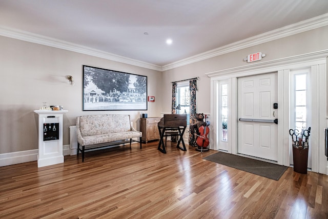 entrance foyer with hardwood / wood-style flooring and ornamental molding