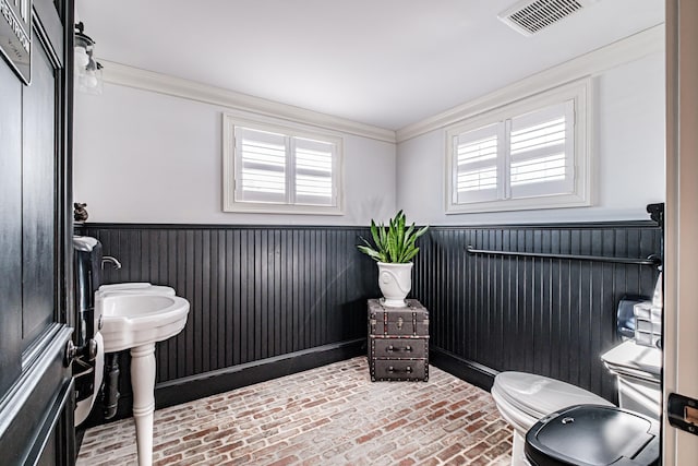 bathroom with toilet and ornamental molding