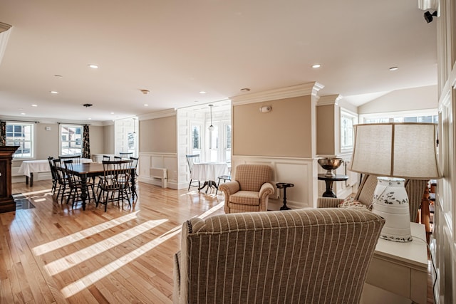 living room featuring light wood-type flooring and ornamental molding