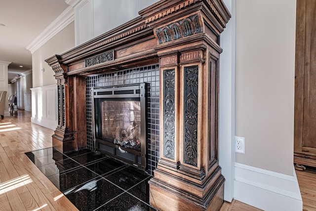 room details featuring ornamental molding and a tiled fireplace