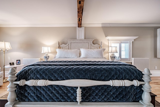 bedroom with hardwood / wood-style floors and radiator heating unit