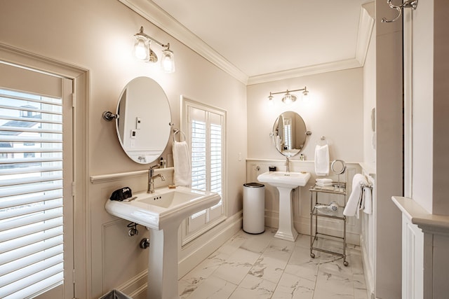 bathroom with ornamental molding and dual sinks