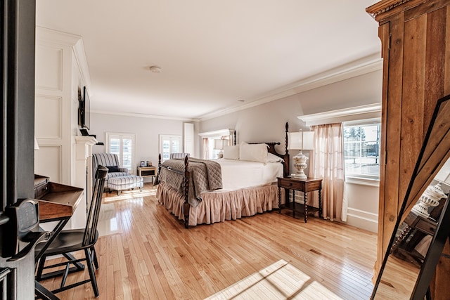 bedroom featuring light wood-type flooring and crown molding