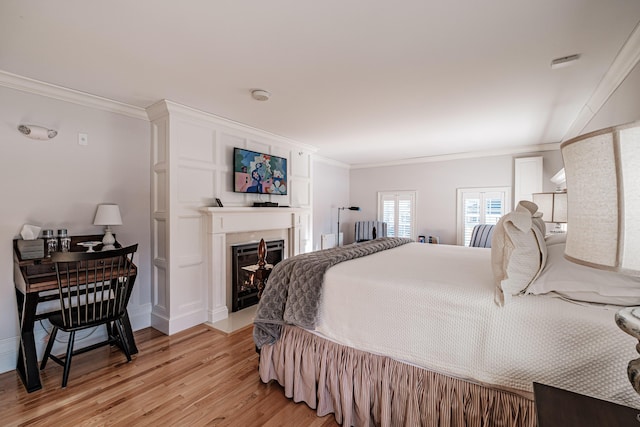 bedroom featuring light hardwood / wood-style floors and crown molding