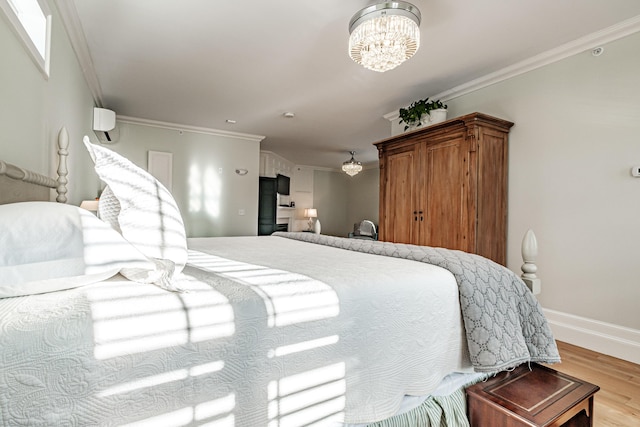 bedroom featuring crown molding, an inviting chandelier, and light wood-type flooring