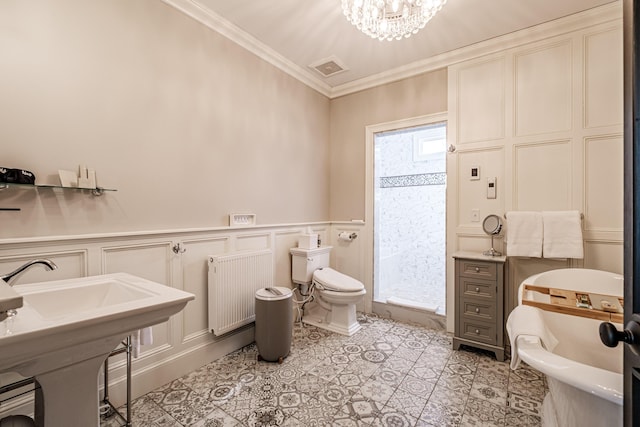 bathroom with radiator, toilet, a tub to relax in, ornamental molding, and a notable chandelier