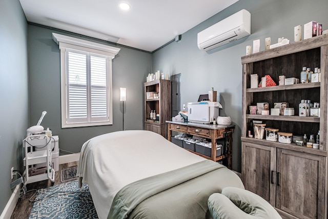 bedroom with dark hardwood / wood-style floors and a wall mounted air conditioner