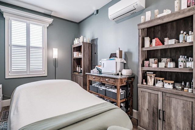 bedroom with a wall unit AC and hardwood / wood-style flooring