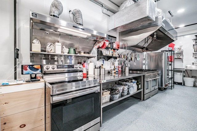 kitchen featuring stainless steel counters, extractor fan, and high end appliances