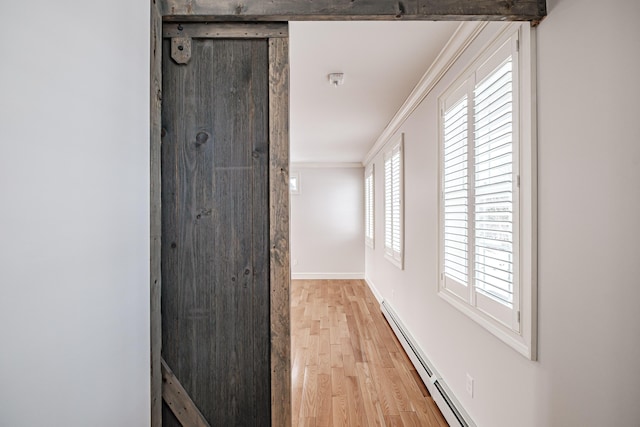 hall featuring baseboard heating, ornamental molding, and light hardwood / wood-style flooring