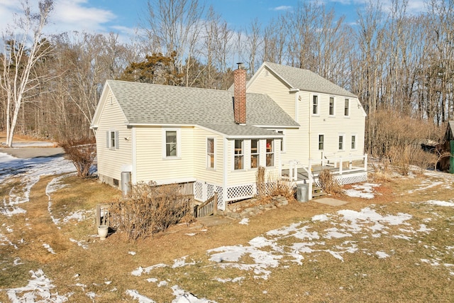 view of snow covered rear of property