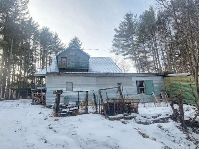 view of snow covered rear of property