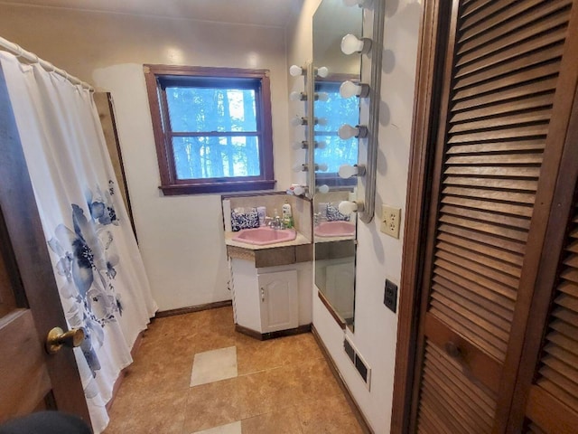 bathroom featuring vanity and a shower with shower curtain