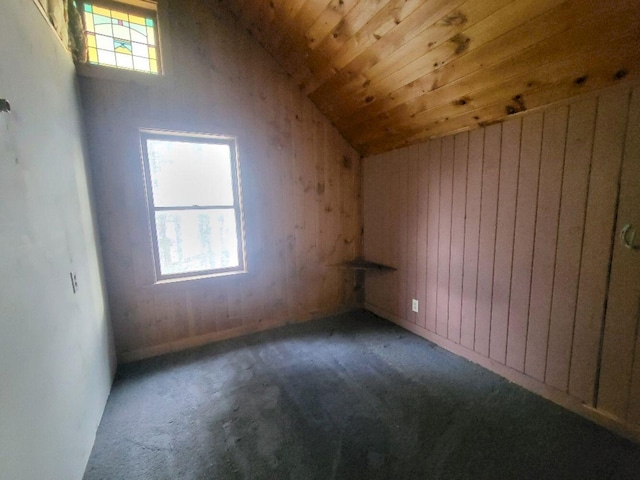 bonus room featuring carpet floors, lofted ceiling, wood walls, and wood ceiling