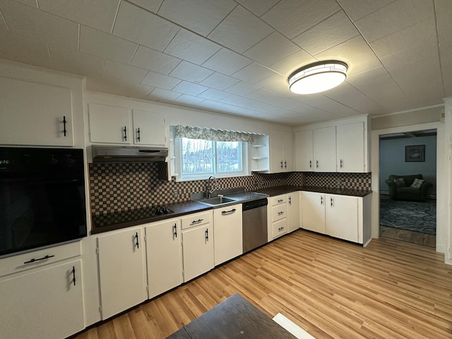 kitchen featuring backsplash, sink, black appliances, light hardwood / wood-style flooring, and white cabinetry