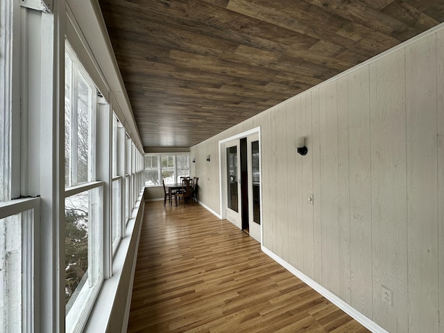 unfurnished sunroom featuring wooden ceiling