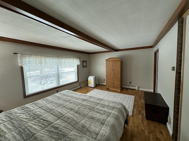 bedroom with wood-type flooring and a baseboard radiator