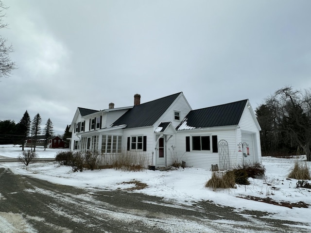 view of snow covered rear of property