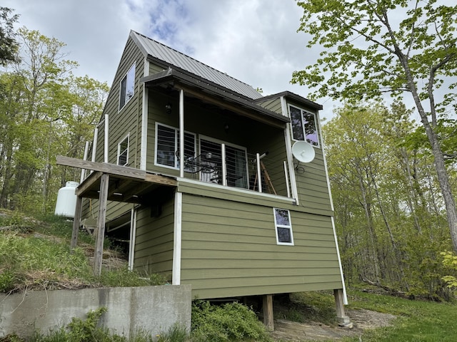 view of side of home featuring a balcony