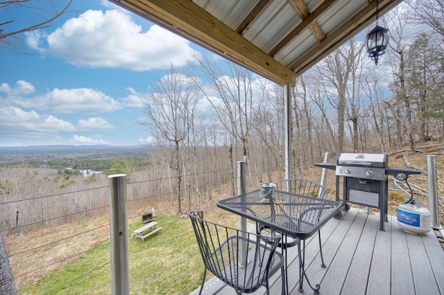 wooden deck with a grill