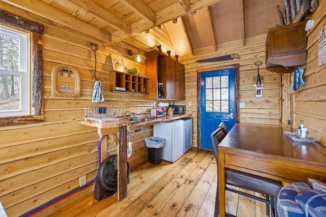 kitchen featuring beamed ceiling, light hardwood / wood-style floors, a wealth of natural light, hanging light fixtures, and wood ceiling