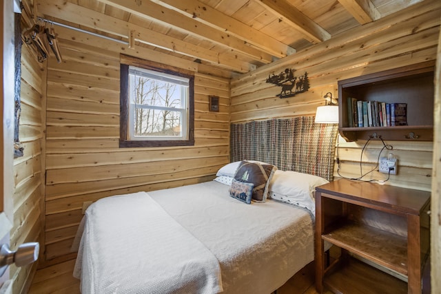 bedroom with wooden walls, wood ceiling, and beamed ceiling